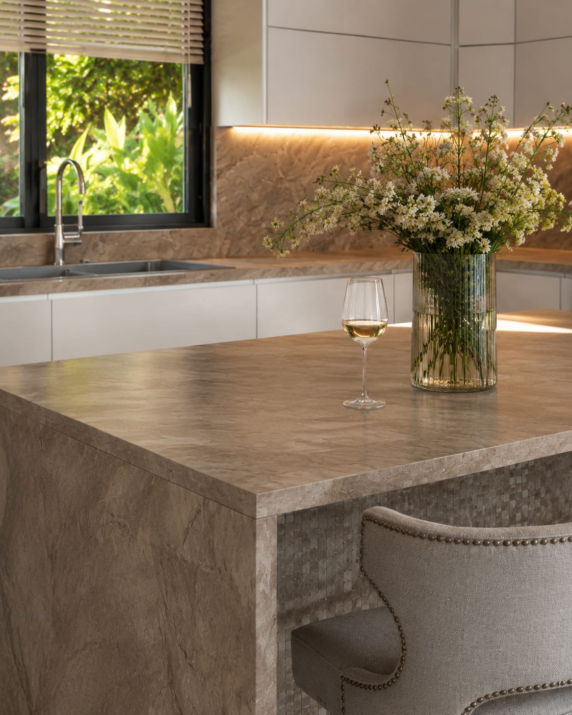 White wine glass on a modern kitchen counter overlooking the ocean at sunset, Casa Quatro, Valle de Samsara, Nicaragua.